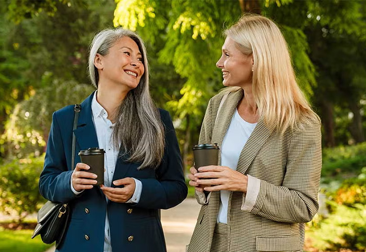 Two women chatting in a park
