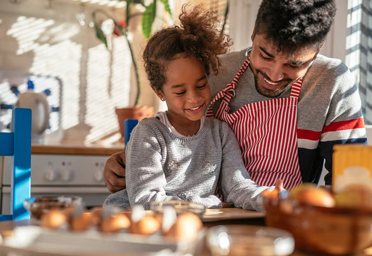 Father and child working outside at a table