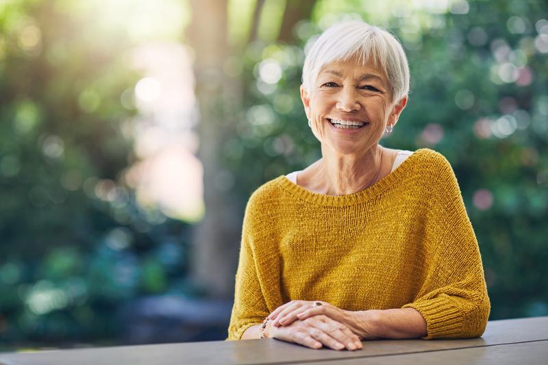Middle-aged women sitting in a gold sweater