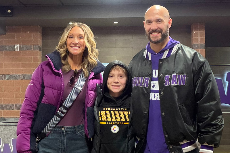 Drew Strube standing with his family